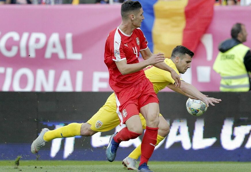 epa07092667 Serbia's Nikola Milenkovic (L) vies for the ball with Romania's George Tucudean (R) during the UEFA Nations League, league C, group 4, soccer match between Romania and Serbia at the National Arena in Bucharest, Romania, 14 October 2018.  EPA-EFE/ROBERT GHEMENT