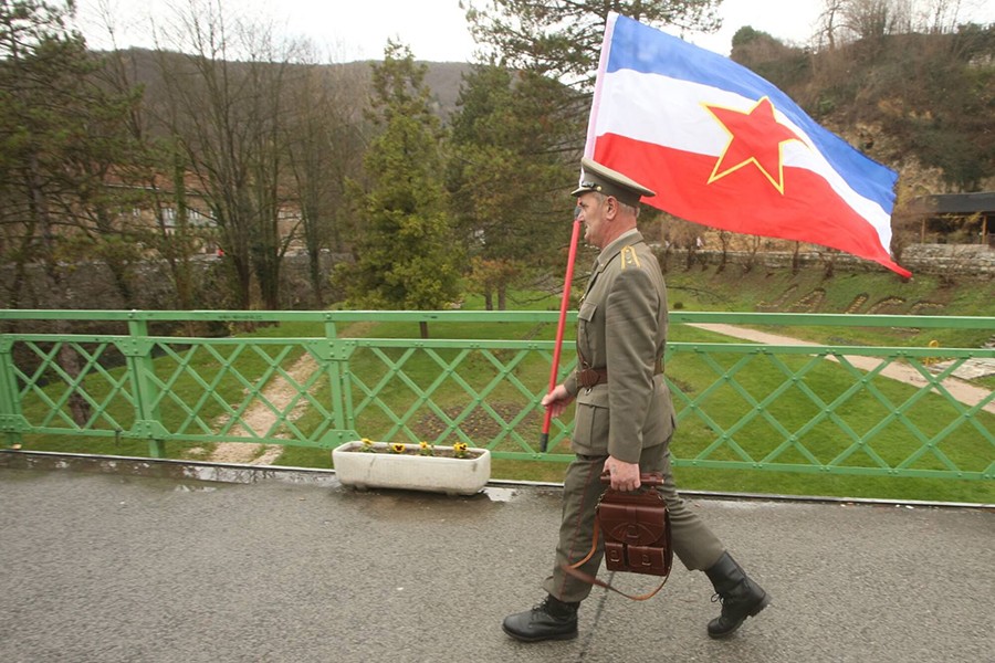 čovjek nosi jugoslovensku zastavu