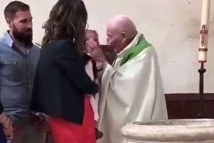JEZIV POTEZ SVEŠTENIKA Snimak s krštenja sve ostavio u šoku (VIDEO)