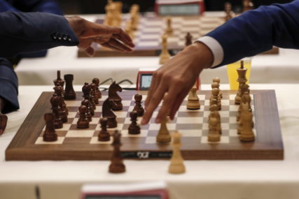 Dvije ruke nad šahovskom tablom
