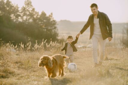Tata i dijete šetaju sa psom