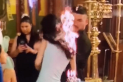 (VIDEO) GORE MREŽE Kuma se zapalila u crkvi tokom krštenja, snimak postao viralan